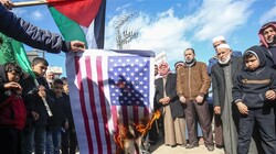 Palestinian demonstrators burn a US flag during a protest against the so-called deal of the century in Khan Yunis in the southern Gaza Strip on January 31, 2020. (Photo by AFP)