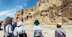 Foreign travelers look at ancient rock–hewn tombs and bas-relief carvings at Naqsh-e Rostam, which is situated near the UNESCO-registered Persepolis southern Iran. (Photo: Richard I’Anson)