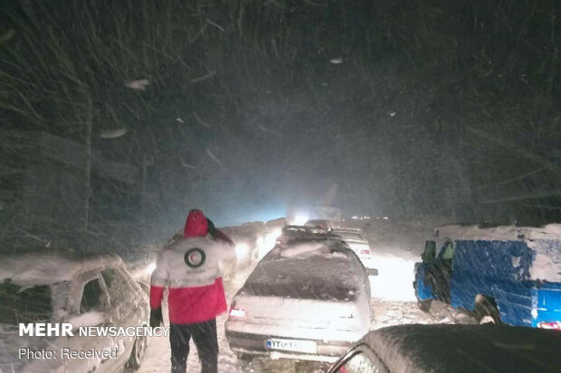 Rescue operation to help people stranded in vehicles stuck in snow
