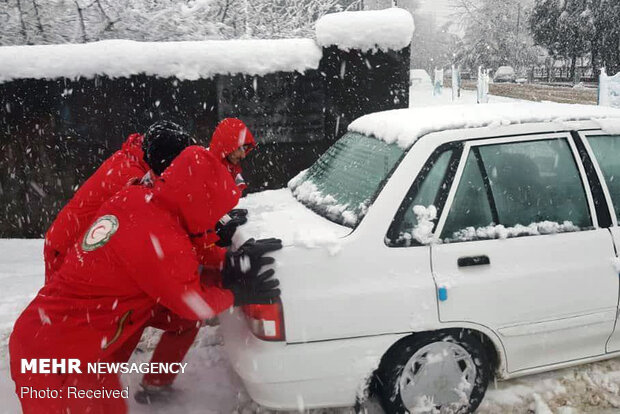 Rescue operation to help people stranded in vehicles stuck in snow
