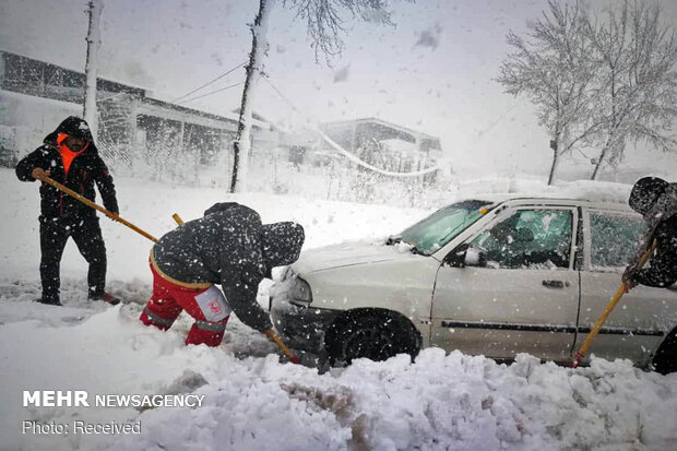 Rescue operation to help people stranded in vehicles stuck in snow
