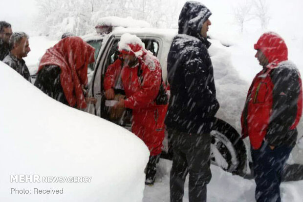 Rescue operation to help people stranded in vehicles stuck in snow
