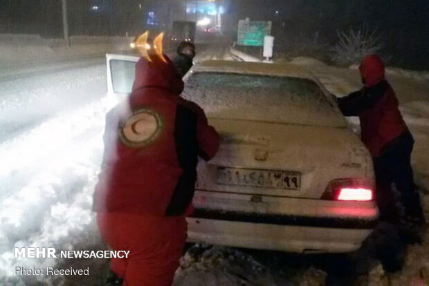 Rescue operation to help people stranded in vehicles stuck in snow
