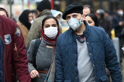 Iranian couple wearing protective masks to prevent contracting a coronavirus walk at Grand Bazaar in Tehran, Iran February 20, 2020. Photo credit: WANA (West Asia News Agency)