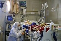 An Iranian medic treats a patient infected with COVID-19 at a hospital in Tehran on Sunday. Photo: AFP