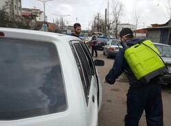 VIDEO: Youths in Rasht disinfecting passing cars against COVID-19
