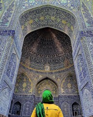 A traveler looks at the main portal of Imam Mosque in Isfahan, central Iran.