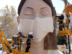 The World Health Organization called the COVID-19 viral disease a pandemic Wednesday. Here, workers in Spain place a medical mask on a figure that was to be part of the Fallas festival in Valencia. The festival has been canceled over the coronavirus outbreak. (Photo: Alberto Saiz/AP)