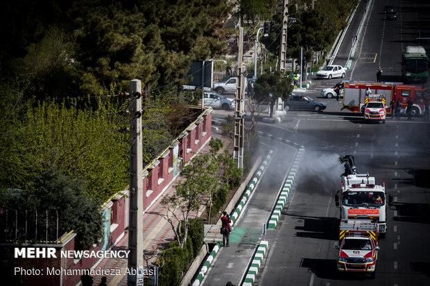 Firefighters disinfecting a neighborhood in E Tehran
