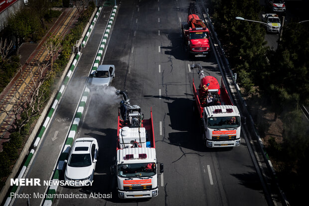 Firefighters disinfecting a neighborhood in E Tehran
