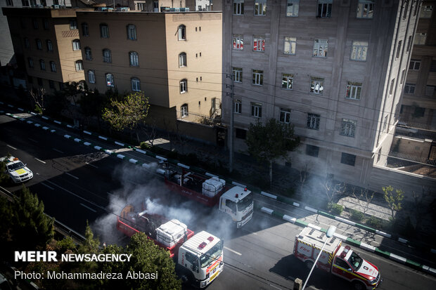 Firefighters disinfecting a neighborhood in E Tehran
