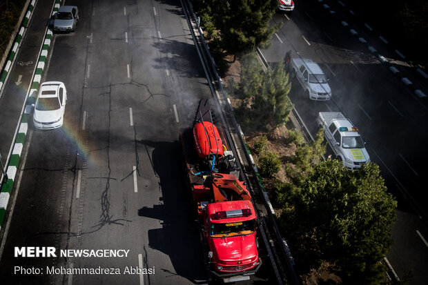 Firefighters disinfecting a neighborhood in E Tehran
