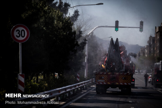 Firefighters disinfecting a neighborhood in E Tehran
