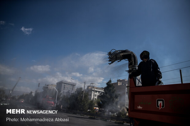 Firefighters disinfecting a neighborhood in E Tehran
