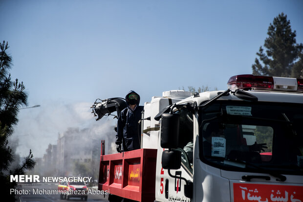 Firefighters disinfecting a neighborhood in E Tehran
