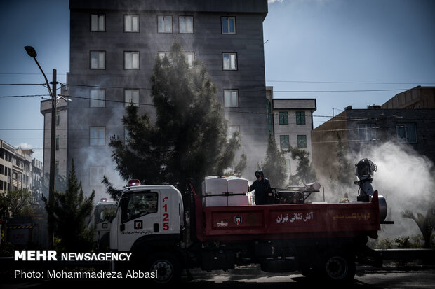 Firefighters disinfecting a neighborhood in E Tehran
