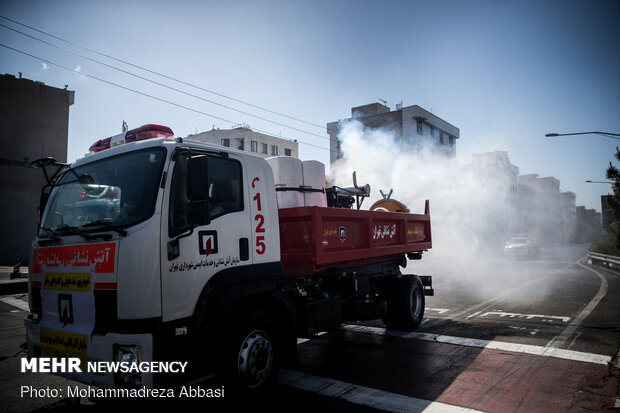 Firefighters disinfecting a neighborhood in E Tehran
