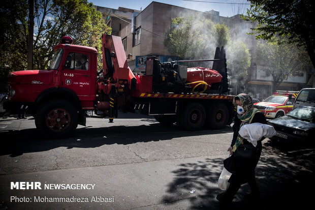 Firefighters disinfecting a neighborhood in E Tehran
