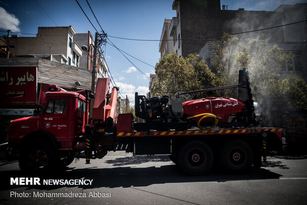 Firefighters disinfecting a neighborhood in E Tehran
