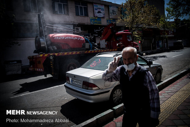 Firefighters disinfecting a neighborhood in E Tehran
