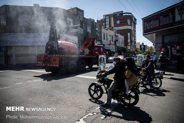 Firefighters disinfecting a neighborhood in E Tehran
