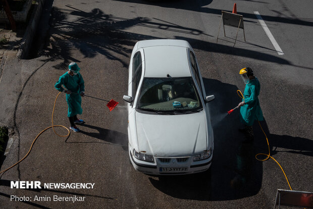 Students disinfect passing cars against COVID-19 in Shiraz