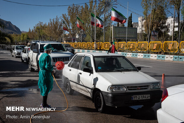 Students disinfect passing cars against COVID-19 in Shiraz