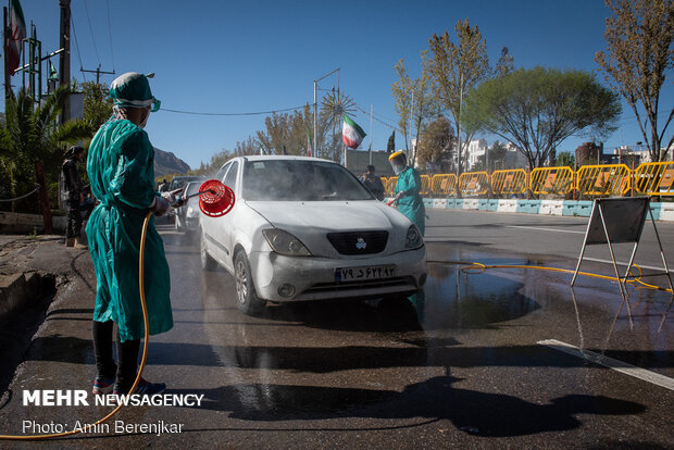 Students disinfect passing cars against COVID-19 in Shiraz