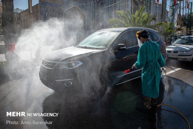 Students disinfect passing cars against COVID-19 in Shiraz