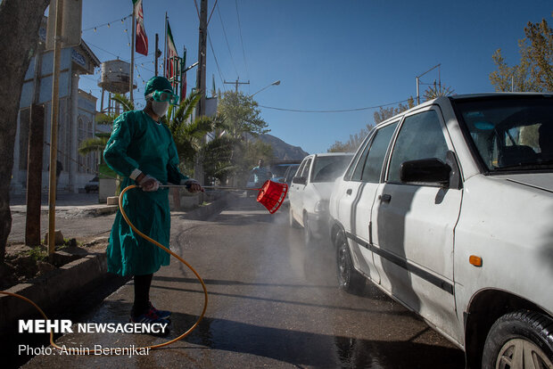 Students disinfect passing cars against COVID-19 in Shiraz