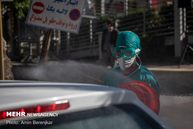 Students disinfect passing cars against COVID-19 in Shiraz