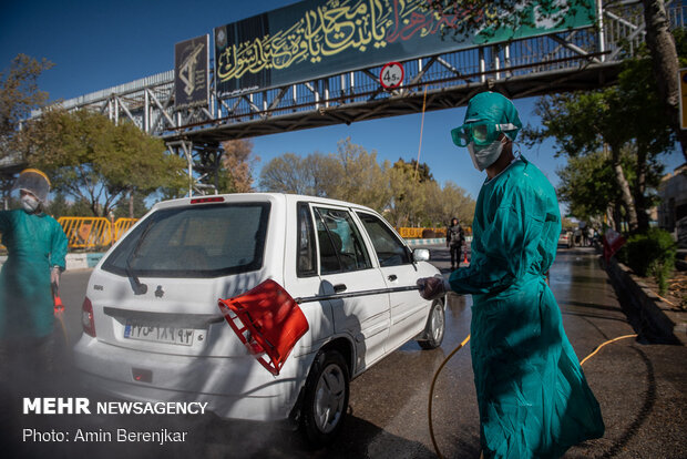 Students disinfect passing cars against COVID-19 in Shiraz