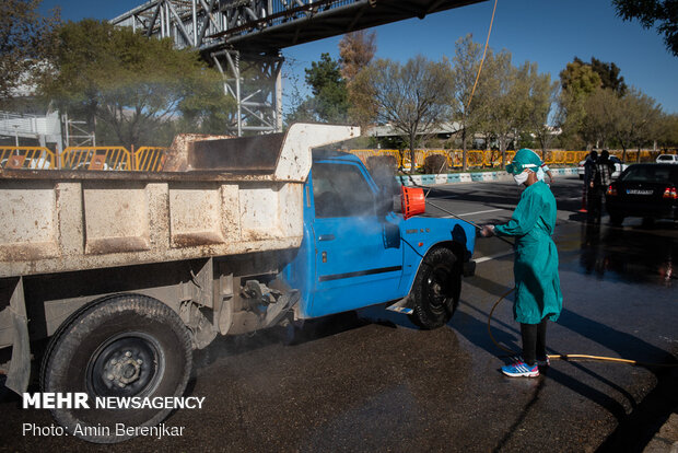 Students disinfect passing cars against COVID-19 in Shiraz