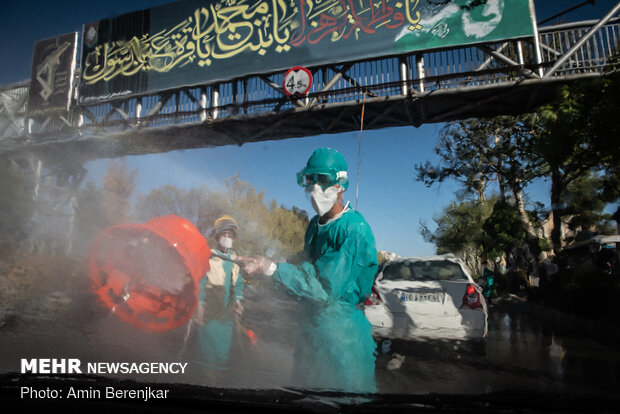 Students disinfect passing cars against COVID-19 in Shiraz