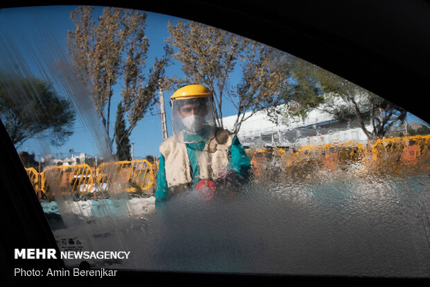 Students disinfect passing cars against COVID-19 in Shiraz