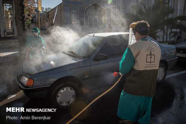 Students disinfect passing cars against COVID-19 in Shiraz