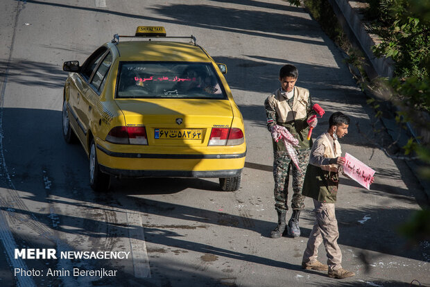 Students disinfect passing cars against COVID-19 in Shiraz