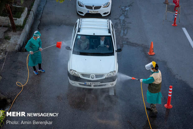 Students disinfect passing cars against COVID-19 in Shiraz