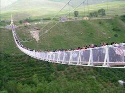 Sightseers cross a gigantic suspension bridge linking two hills in Meshkinshahr, Iran’s Ardabil province.
