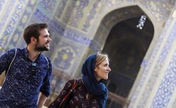 File photo depicts foreign nationals looking at intricate tilework that covers interior spaces of the Imam Mosque, one of the must-see travel destinations in Isfahan, central Iran.