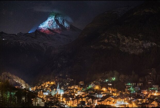 Mountain in Swiss lit up with a projection of Iran's flag 