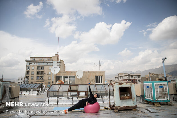 Iranians working out on rooftops amid the pandemic