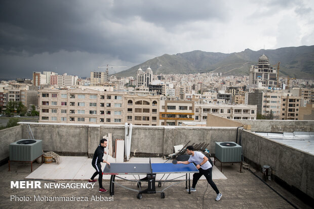 Iranians working out on rooftops amid the pandemic