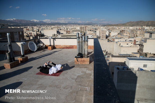 Iranians working out on rooftops amid the pandemic