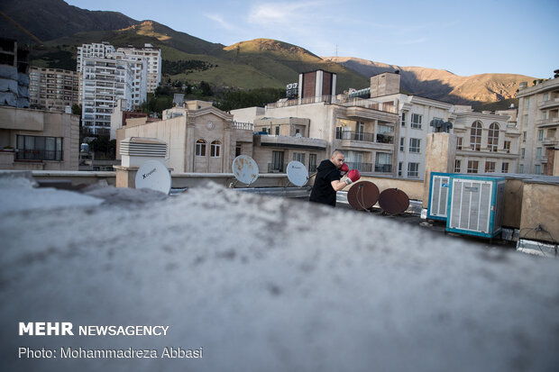 Iranians working out on rooftops amid the pandemic