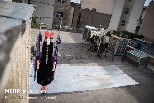 Iranians working out on rooftops amid the pandemic