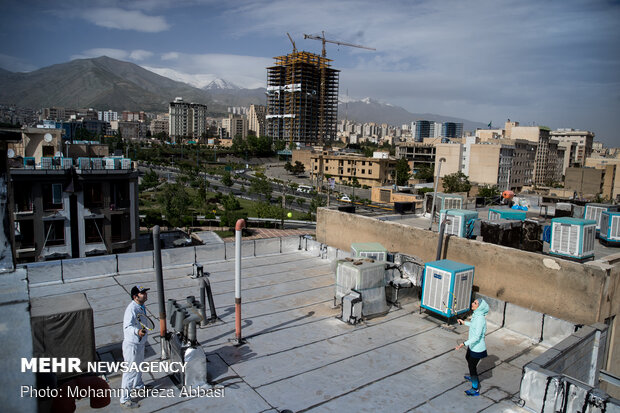 Iranians working out on rooftops amid the pandemic