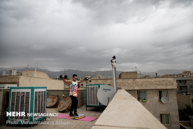 Iranians working out on rooftops amid the pandemic