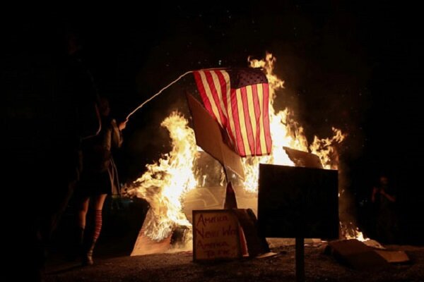 متظاهرون امريكيون يحرقون العلم الامريكي في مدينة بورتلاند