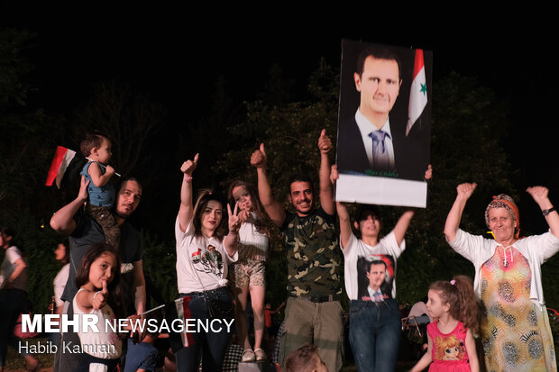 Syrian people celebrating victory of Bashar Asad in election